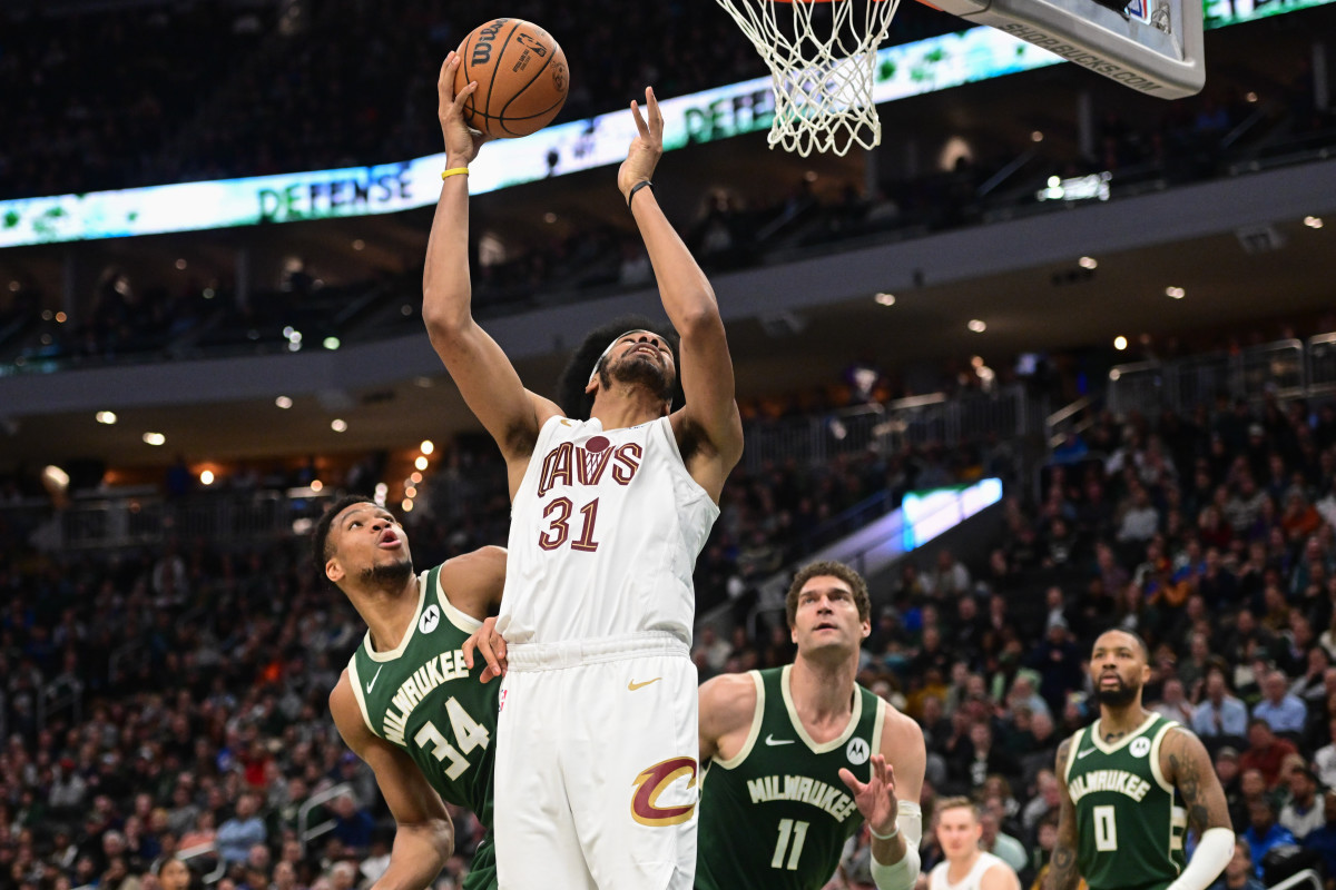 Jan 24, 2024; Milwaukee, Wisconsin, USA; Cleveland Cavaliers center Jarrett Allen (31) takes a shot between Milwaukee Bucks forward Giannis Antetokounmpo (34) and center Brook Lopez (11) in the fourth quarter at Fiserv Forum.